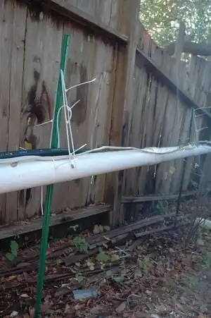 Fig 3:Greywater piping running along fence. (slope is downward, but looks different because fence is steeper than piping)