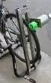 Pic 3: Slightly blurry image of generator unit attached to struts and mounted on the bike stand. Note that the friction wheel contacts bike wheel, but can be rotated away from lower pivot point, allowing bike to removed