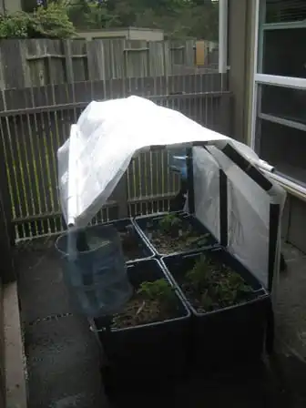 The GnomeTainer Modular, raised garden with integrated rain catchment that can be installed on a porch