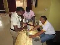 A medical officer drills the bone simulator prototype