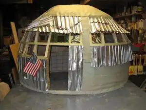 Aluminum Awareness Aluminum can shingles and 2-liter bottle windows