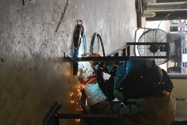 Jesse Davis, a local machinist, welds the main frame.