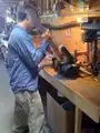 Fig 3: Jerome (HSU student) filing one of the beams in John's shop.