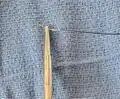 The suture needle should be angled approximately 30 degrees forward when loaded appropriately.