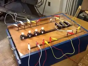 Electrical wiring apparatus Device to teach series and parallel wiring using intrigue