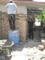 Fig 1b: Juan teaching us how to build our first wall