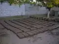 Fig 8: The field of freshly made adobes now awaits the next day or two to be dry enough to handle.