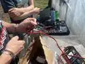 Stripping the wire to connect it to the fuse.