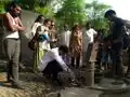 Taking water samples from a government water supply pipe